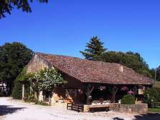 Barn bar-lounge of Domaine de Gavaudun cottages resort and holiday park in Dordogne Lot